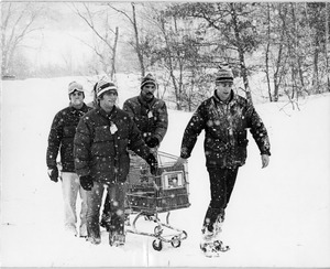 Students pull shopping cart through snow during the Blizzard of '78