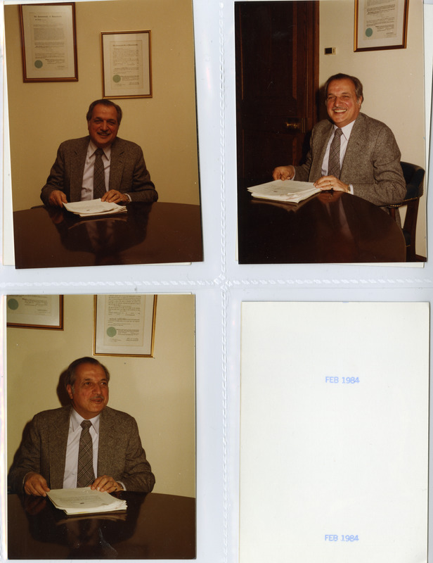 President Gregory Adamian reading papers in his office