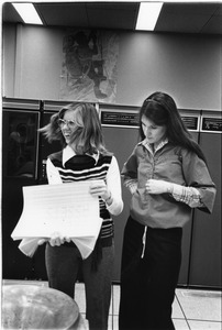 Two women with print from mainframe computer
