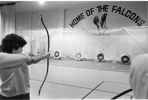 Student practices archery in the Dana Center