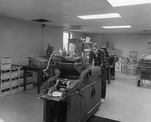 Man operating machinery in mail room