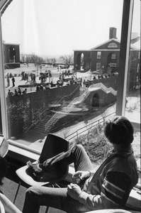 Student in LaCava Center looks out to main campus quad