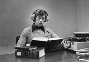 Student studying while listening to record
