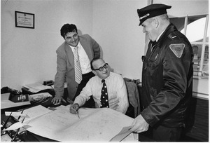 Campus Police and Bob Weafer surveying blueprints