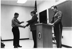 Member of Campus Police receiving document
