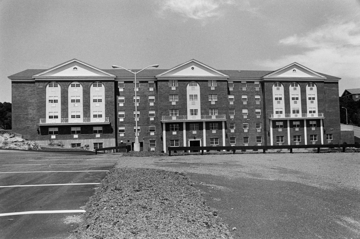 View of Collins Hall dormitory from parking lot