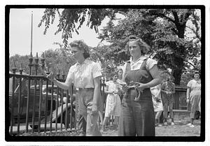 Two young women playing horseshoes