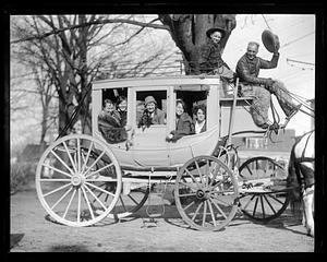 People smiling from a horse-drawn carriage