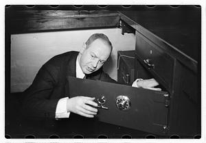 A man demonstrating how to break into a safe