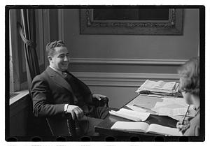 A man seated at a desk