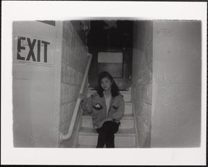 Young woman sitting in a stairwell