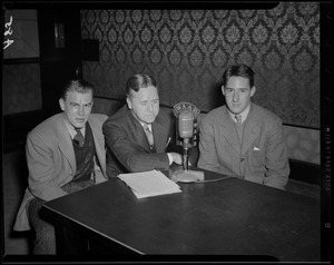 Three unidentified men at WAAB microphone