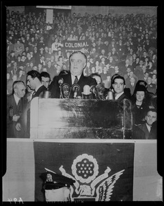 Montage of Franklin Roosevelt speaking from podium and a crowd holding a Colonial Network banner