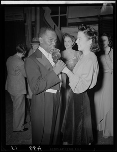 Ruth Moss of WNAC interviewing an unidentified man in a tuxedo backstage