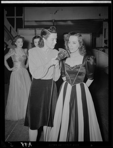 Ruth Moss of WNAC interviewing an unidentified woman in a gown backstage