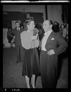 Ruth Moss of WNAC interviewing an unidentified man in a tuxedo backstage
