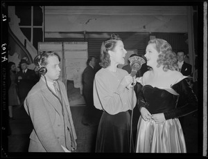 Ruth Moss of WNAC interviewing an unidentified woman in a gown backstage