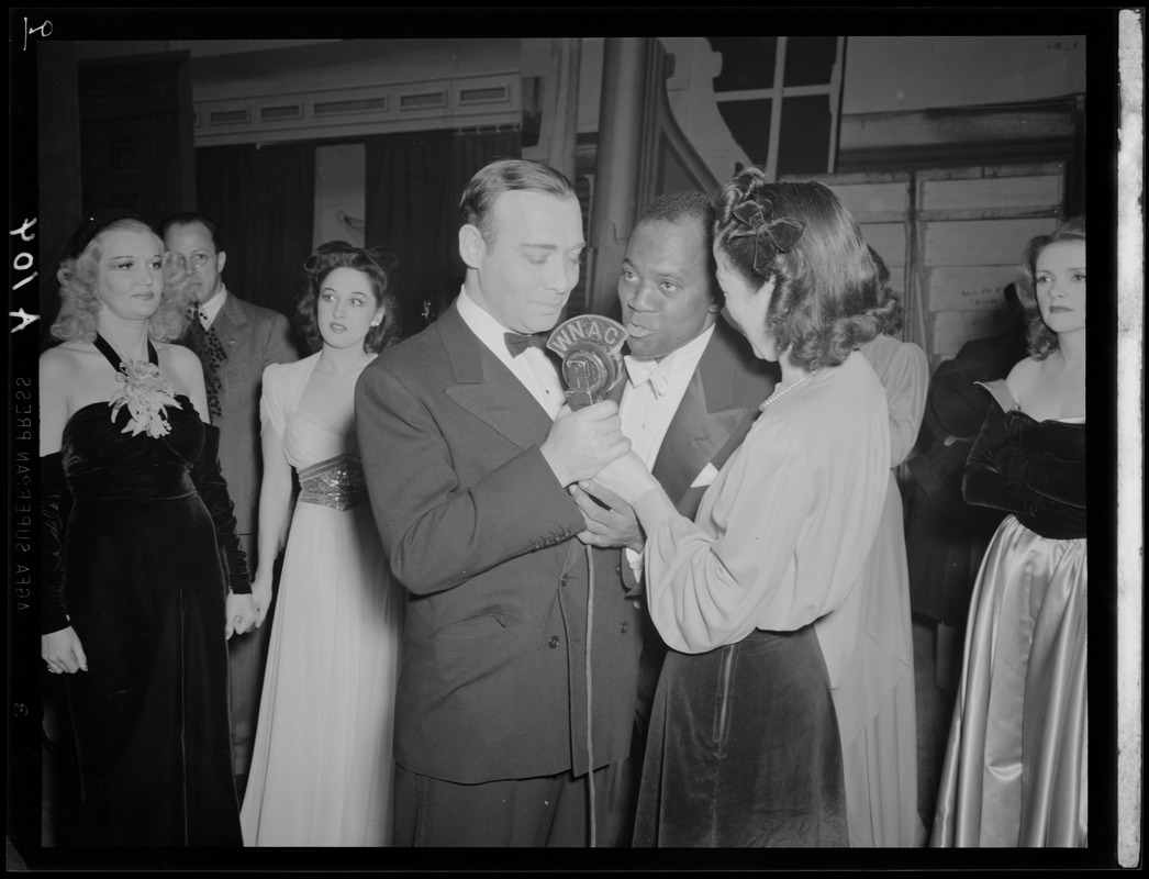 Ruth Moss of WNAC interviewing two unidentified men in a tuxedos backstage