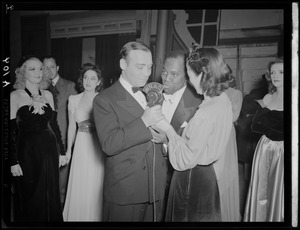 Ruth Moss of WNAC interviewing two unidentified men in a tuxedos backstage