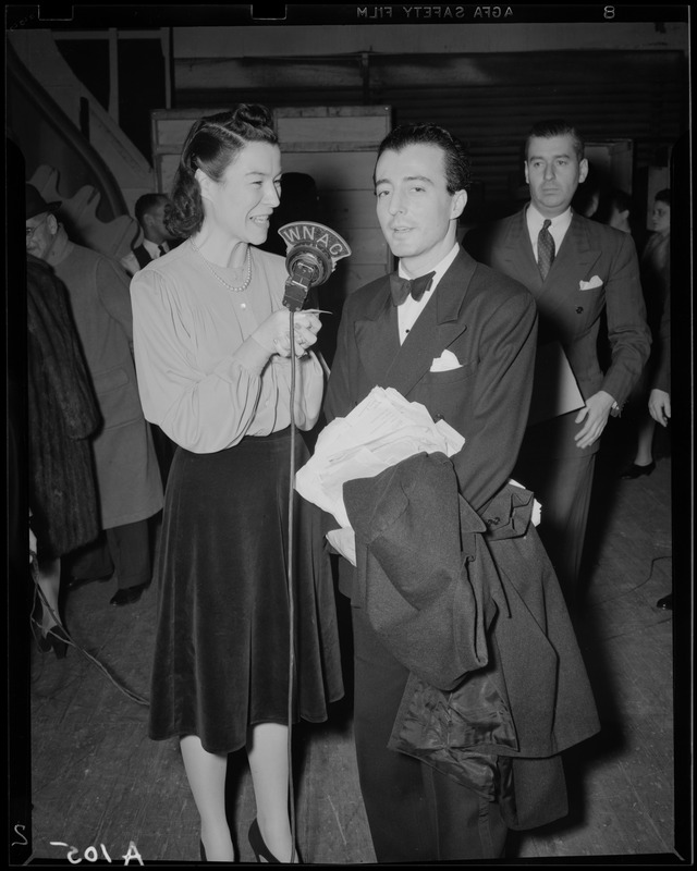 Ruth Moss of WNAC interviewing an unidentified man in a tuxedo backstage