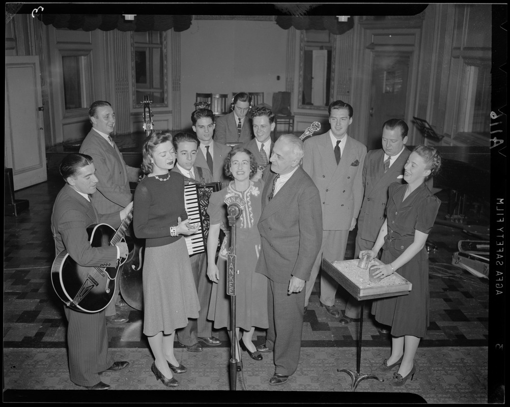 Band gathered around WNAC microphone