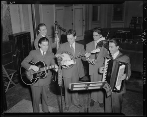 Band gathered around WNAC microphone