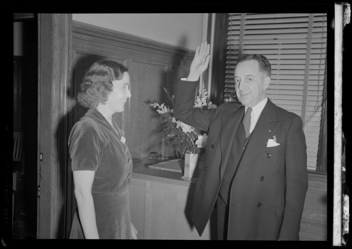 Unidentified woman and man with his hand raised