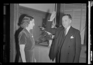 Unidentified woman and man with his hand raised