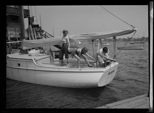 Three people on sailboat named Dugong