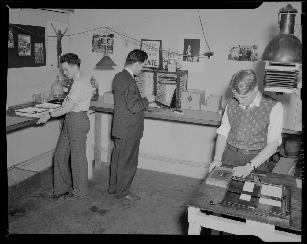 Three unidentified working men in photography studio