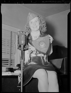 Dixie holding plaque from Our Army magazine to Yankee-Colonial Network at Fort Devens