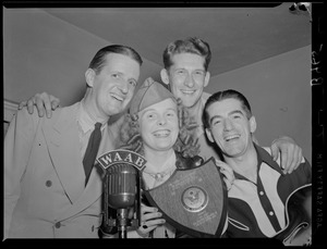 George and Dixie with two unidentified men and plaque from Our Army magazine to Yankee-Colonial Network at Fort Devens