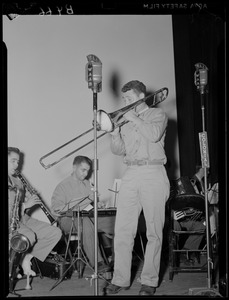 Soldier playing a trombone during a WAAB broadcast at Fort Devens
