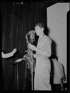 Soldier playing a saxophone during a WAAB broadcast at Fort Devens