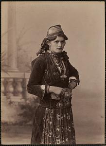 Studio portrait of woman in traditional Greek dress