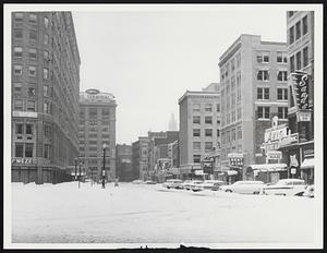Typical Boston Scene, yesterday, shows empty stores and streets after first winter storm of the year dumped six inches of snow on the city, which was jammed with last-minute shoppers the day before.