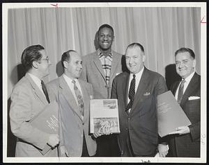 Members of the Celtics Family, Coach Red Auerbach, Center Bill Russell and Owner Walter Brown, left to right, who yesterday were guests at Crosscup-Pishon Post American Legion party. Brown was presented a leather-bound copy of the next issue of The Saturday Evening Post which will carry a feature article about the Celtics.