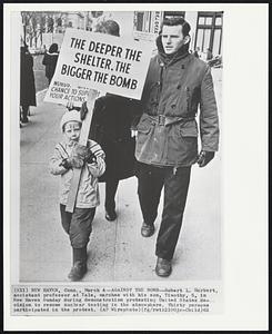 Against the Bomb--Robert L. Herbert, assistant professor at Yale, marches with his son, Timothy, 5, in New Haven Sunday during demonstration protesting United States decision to resume nuclear testing in the atmosphere. Thirty persons participated in the protest.