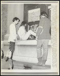 Groom Richard Eagen watches as his bride, Andrea Boroff, climbs through window of Fayerweather Hall to resume protest against university policy 4/28. The couple, who have helped occupy Fayerweather Hall since campus insurrection began seven days ago, left the building briefly after being married there and returned to continue the protest.