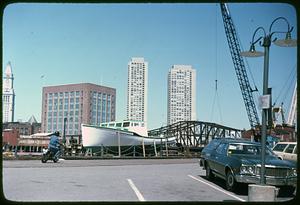 A boat in foreground, Northern Avenue Bridge, James Hook + Co., Harbor Towers and Custom House Tower in background