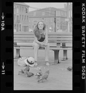 Beth Johnson on Market Square bench with pigeons