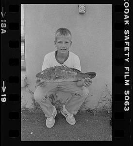 Boy holding fish