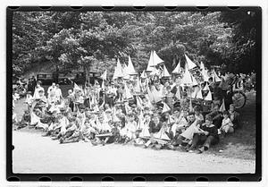 Boys holding model sailboats