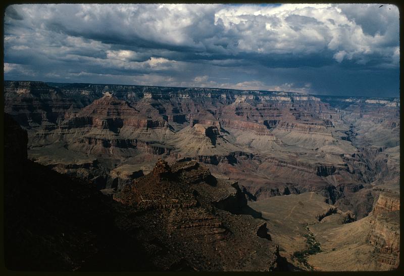 View of Grand Canyon with shadowed cliff in foreground, Arizona