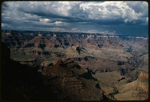 View of Grand Canyon with shadowed cliff in foreground, Arizona