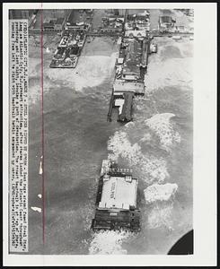 Steel Pier Ripped by Storm - Seas rage around famed Steel Pier, long an Atlantic City, N.J., resort attraction, after storms lashed the Atlantic Coast throughout yesterday and last night, leaving a path of devastation. The resort boardwalk is at top of photo, running from left to right with boardwalk hotels surrounded by water.