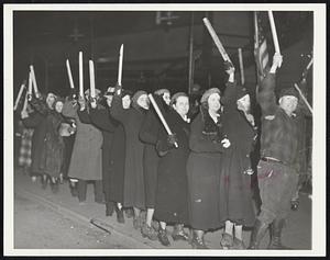 In hand, women members of the emergency brigade are shown in picket line in front of the Chevrolet plant No. 4 at Flint.