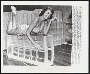 Coooool, Man--It isn't easy to keep cool in drought and heat stricken Oklahoma but pretty Rosanna Grossman has found one way to beat the hot weather. Above, she poses in an ice house while the temperature outside is above 100 degrees. In the past 18 days here, the mercury has gotten above the century mark 14 times.