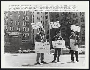 Railroad union men on strike against the Illinois Central Railroad picket the I.C. terminal here 4/9 during 2nd day of walkout. The strike by four operating unions carries with it the threat of a nationwide rail strike. L-R: Bernard Meehan, trainman; Jim Webb, and Gustav Krause, trainmen.