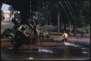 A person walking through Brewer's Fountain, Boston
